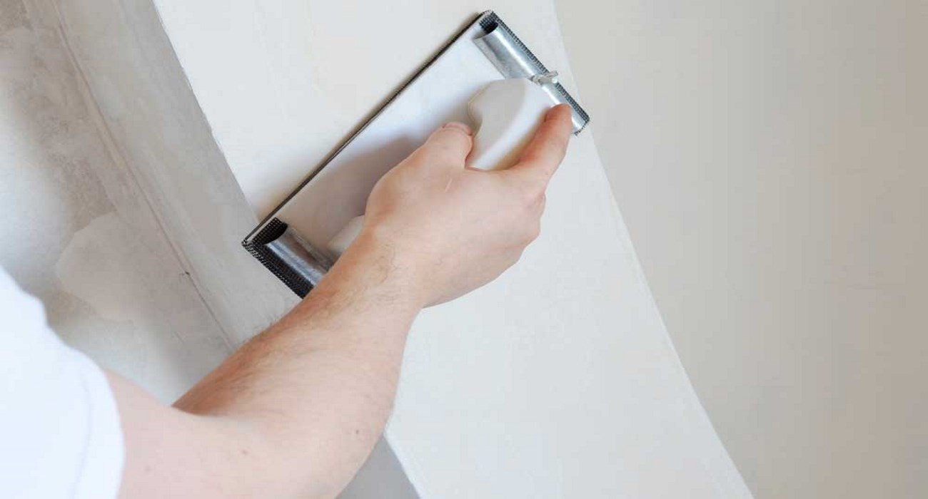 Buchan Consulting uses professional tools to repair drywall cuts made during installation